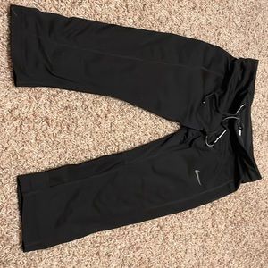 Small black Dri-Fit Nike capri leggings.